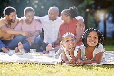 Buy stock photo Food, drink and a family picnic in park with kids, parents and grandparents. Men, women and children relax outdoors in nature. Eating, drinking and laughing, a happy black family outside with girls.
