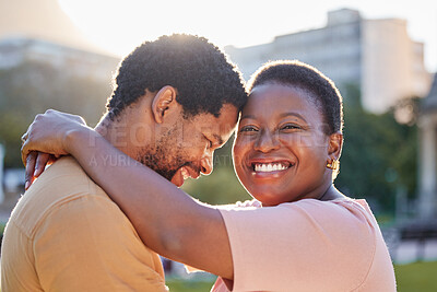 Buy stock photo Happy african couple hugging in outdoor garden on romantic picnic date together during summer time. Smile, love and care between a black man and woman embracing each other while standing outdoors.