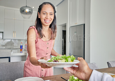 Buy stock photo Wife, healthy food and salad while serving lunch or supper for husband with a smile at home. Caring and happy housewife woman with a dinner plate and enjoying a vegan meal at the table together