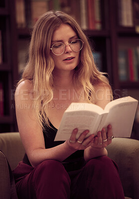 Buy stock photo Reading, book and trendy woman in a library sitting on couch learning and relax in a bookstore or home. Content female with novel for knowledge, study and literature or fiction story 
