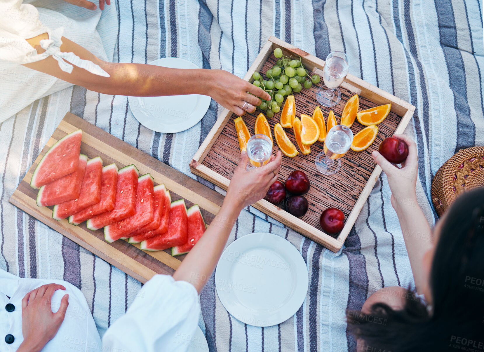 Buy stock photo Hands, picnic and fruits of friends with wine at park eating and drink luxury, nutrition and grape celebration champagne in summer. Women, family or people celebrate with healthy diet food top view