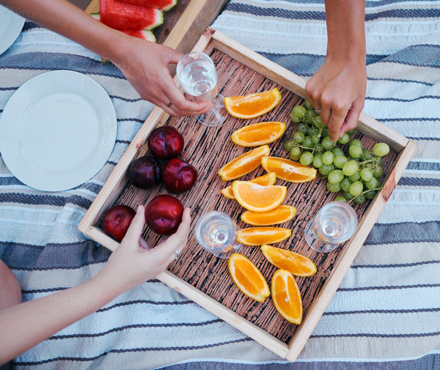 Buy stock photo Picnic, champagne and food with women hands in a park outdoors in summer, fruit, drink and group of friends in nature on the weekend. Diversity, above and a party on the blanket or relax in summer 