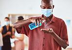 Covid, hand sanitizer and business man with face mask at business meeting for healthcare safety, risk management and compliance. Covid 19, corona virus and policy black man with spray bottle cleaning