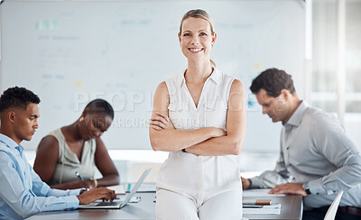 Buy stock photo A woman manager, leader and boss in confident success for team meeting at the office with employees in background. Happy, proud and successful blond female in teamwork leadership and management