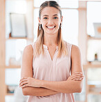 Leadership, smile and happy business woman standing with arms crossed in an office for motivation with a positive mindset. Portrait of female entrepreneur looking satisfied with job or career choice