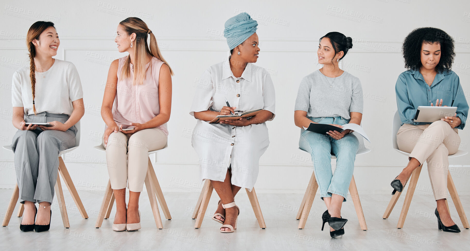 Buy stock photo Diversity, interview and business people in waiting room at a job, hiring or recruitment center. Corporate, women and professionals talking with technology in a unemployment office for a work vacancy