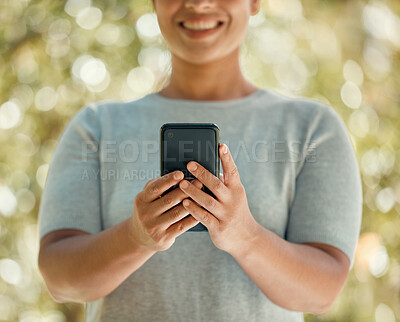 Buy stock photo Phone, communication and woman in nature park while using a mobile app, communication tool or social media messaging outside. Closeup hands of a female with 5g network internet connection outside