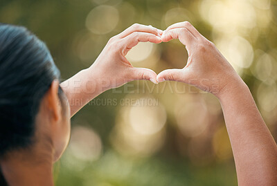 Buy stock photo Woman use hands, make heart or love sign outside with bokeh in nature background. Lady with fingers together, show icon or expression of romance against outdoor backdrop with blurred natural light 