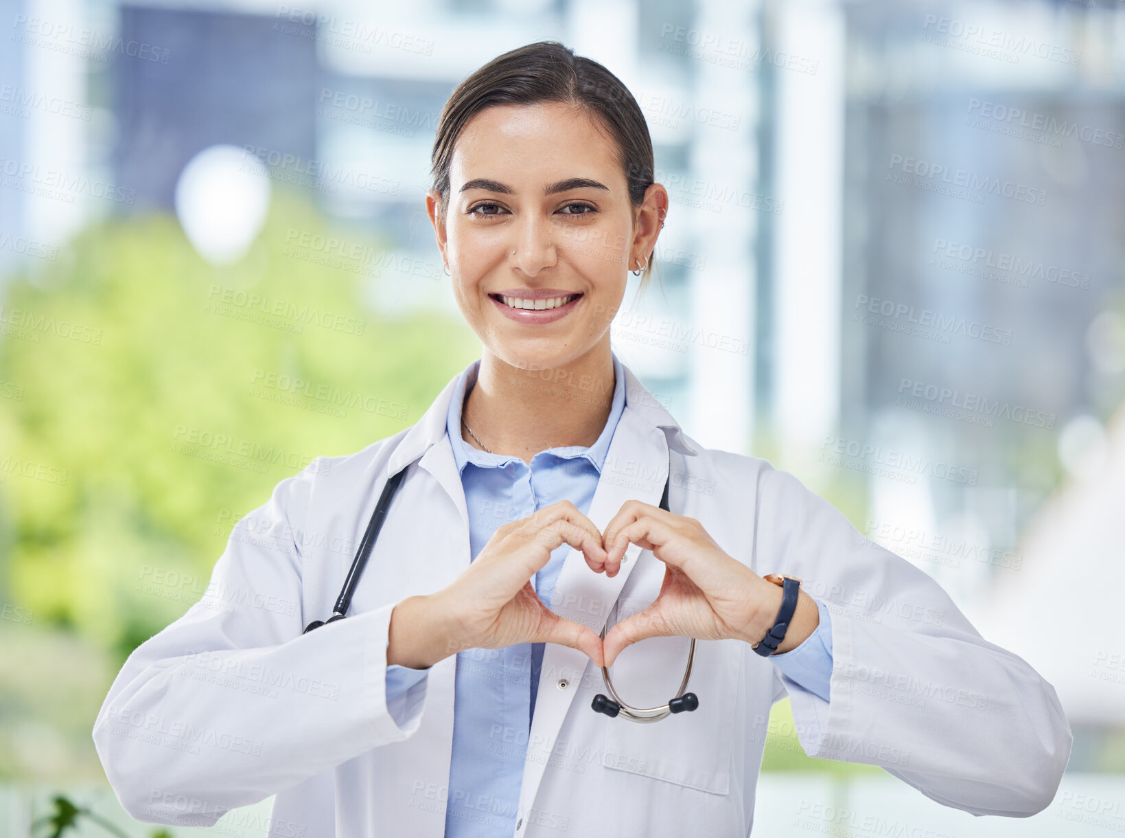 Buy stock photo Heart, hand and icon with happy doctor in medical clinic or hospital. Happy, health and safety in the field of medicine and healthcare while love for her career, job or work while ready to help