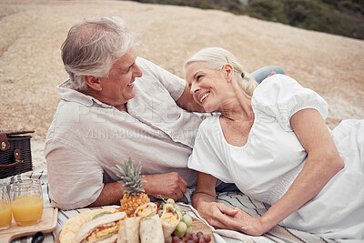 Buy stock photo Love, couple and picnic with a senior man and woman on an outdoor date with food and juice in summer. Happy, smile and romance with an elderly male and female enjoying free time together and bonding