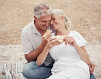 Love, picnic and elderly couple on a romantic date outdoors, celebrating retirement and freedom in a park together. Relax, food and nature with happy man and woman embrace, bonding with affection