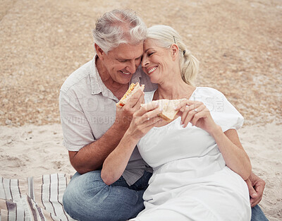 Buy stock photo Love, picnic and elderly couple on a romantic date outdoors, celebrating retirement and freedom in a park together. Relax, food and nature with happy man and woman embrace, bonding with affection