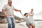 Senior family with kid at the beach for love, support and child development or outdoor wellness. Excited grandparents or people teaching girl to jump, walking near the sea water with healthy energy