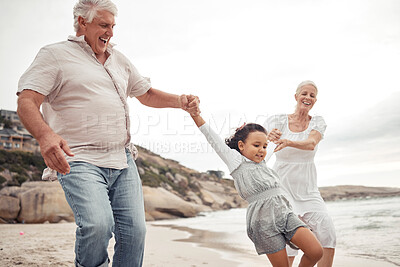 Buy stock photo Senior family with kid at the beach for love, support and child development or outdoor wellness. Excited grandparents or people teaching girl to jump, walking near the sea water with healthy energy
