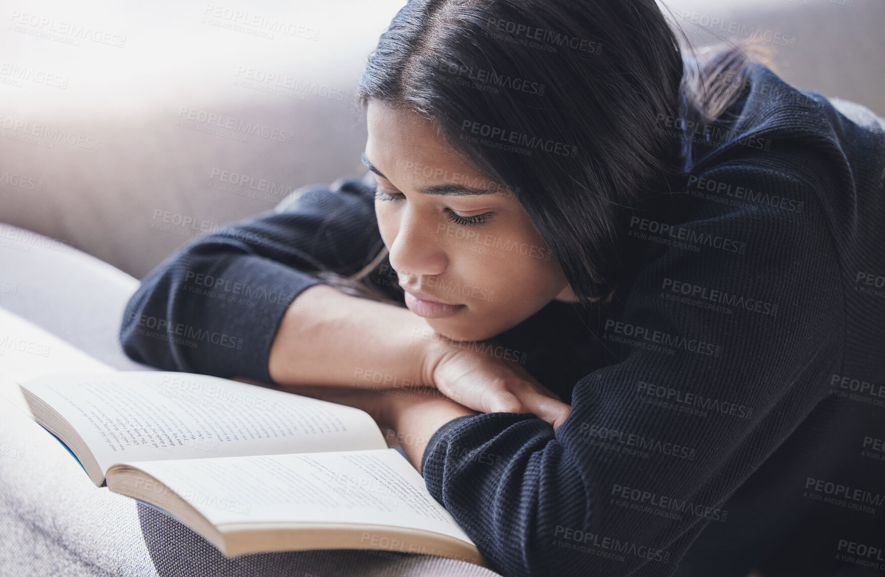 Buy stock photo Reading, book and serious woman on sofa learning and enjoying hobby, relax and free time at home. Mindful female with novel for knowledge, study and literature or fiction story 