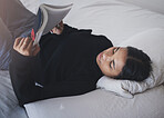 Woman, student and reading book in bedroom for relax, learning and studying at home. Young teenager, college girl and person rest with books in bed for education, knowledge and fiction novel story