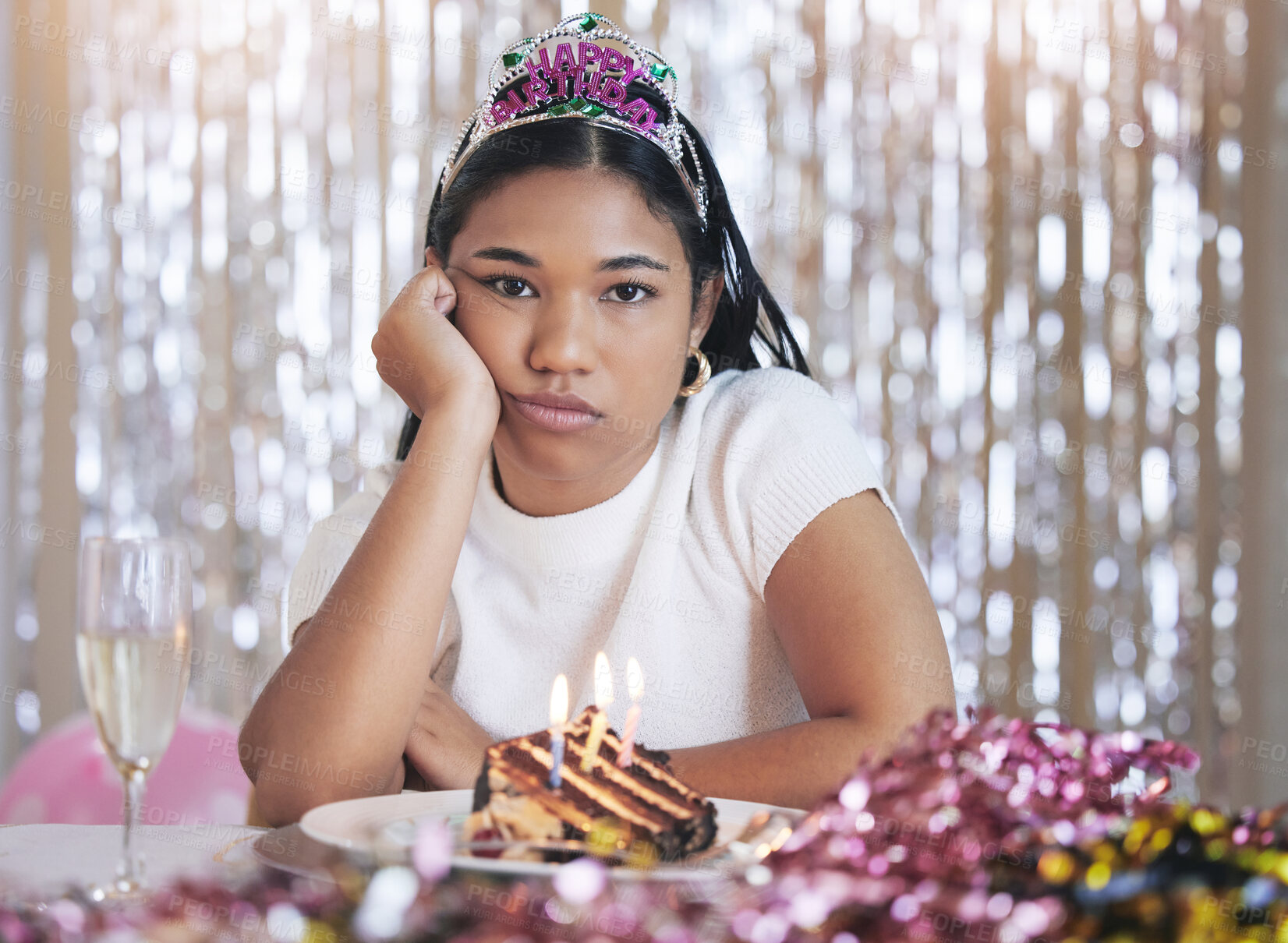 Buy stock photo Bored, angry and birthday girl at a party at a celebration event with cake and candles upset. Portrait of a person from Mexico with sweet food feeling frustrated, sad and unhappy celebrating 