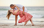 Love, dance and couple dancing at the beach in summer celebrate their marriage, happiness and honeymoon vacation. Smile, sunset and happy woman celebrating a healthy relationship with partner at sea