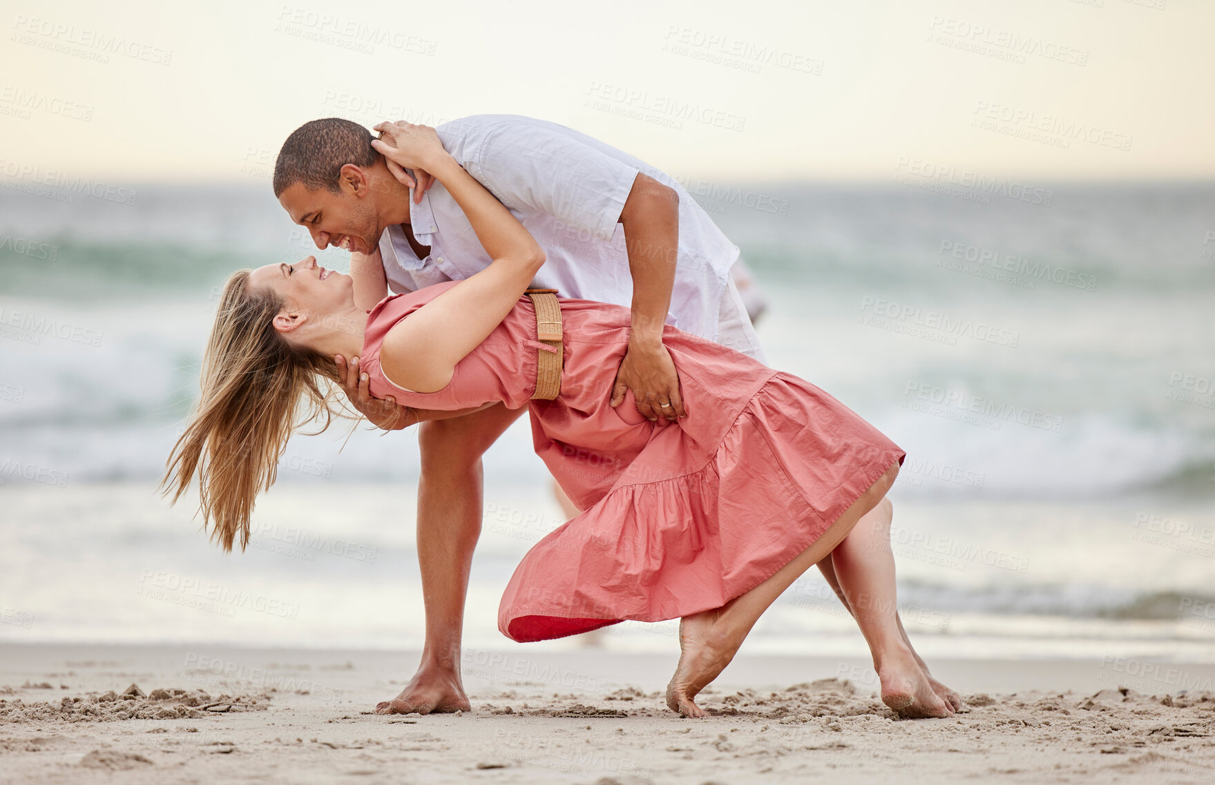 Buy stock photo Love, dance and couple dancing at the beach in summer celebrate their marriage, happiness and honeymoon vacation. Smile, sunset and happy woman celebrating a healthy relationship with partner at sea