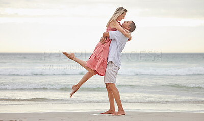 Buy stock photo Interracial couple, love and hugging on a beach by the water in holiday vacation in nature. Man and woman in joyful relationship affection together by the ocean in happiness for the outdoors