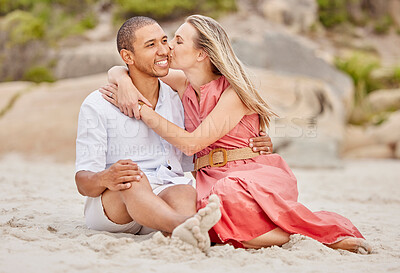 Buy stock photo Kiss, love and couple on beach sand with happy smile for holiday or vacation together. Healthy happiness and interracial man and woman or people relax on ground for wellness lifestyle