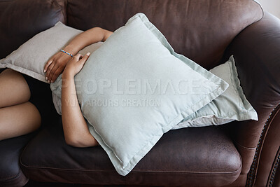 Buy stock photo Tired, depressed girl sleeping under pillow on sofa in the living room. Woman hide feeling sad or anxiety and problem with depression, mental health and fatigue or fear on couch in the lounge