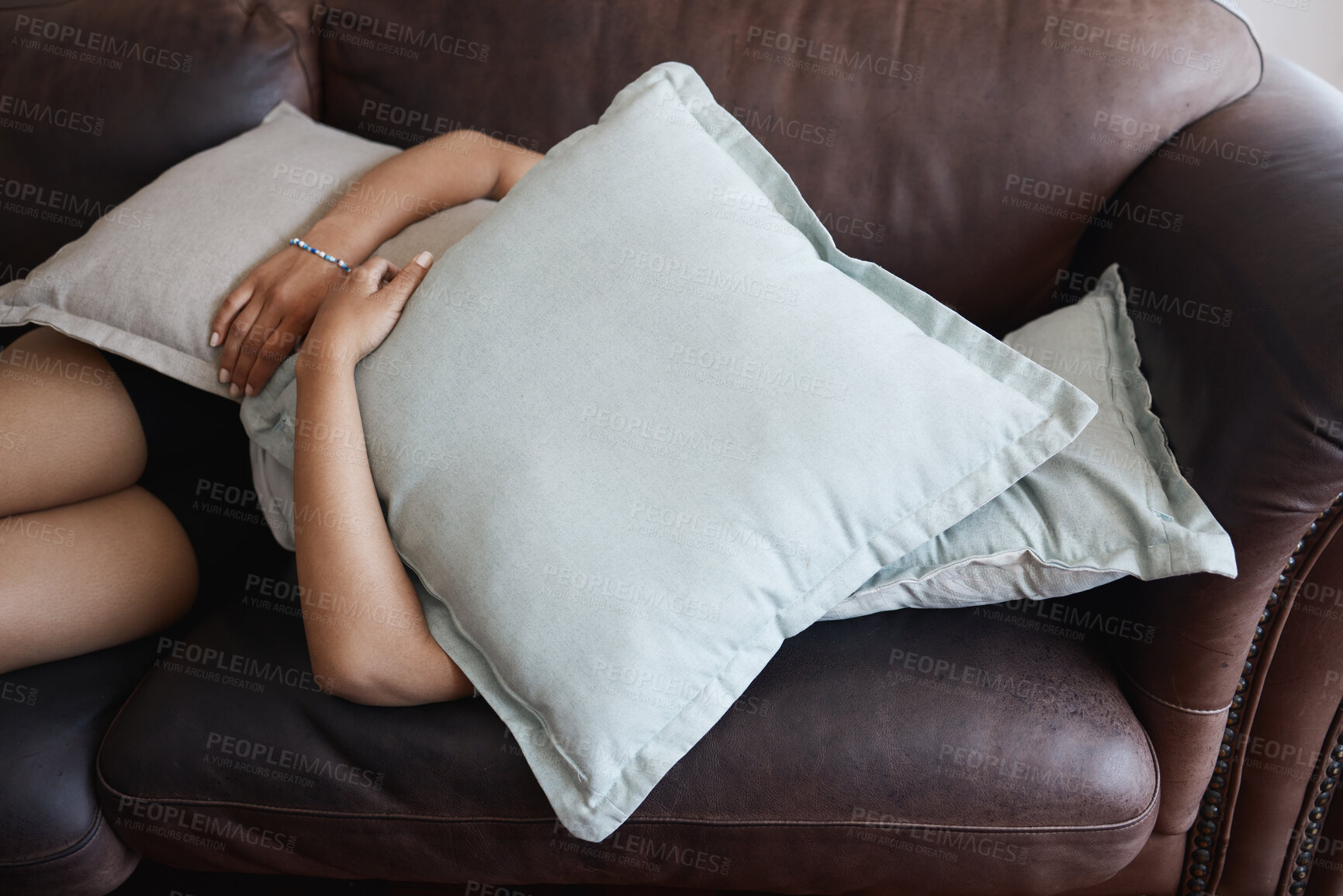 Buy stock photo Tired, depressed girl sleeping under pillow on sofa in the living room. Woman hide feeling sad or anxiety and problem with depression, mental health and fatigue or fear on couch in the lounge