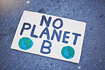 Cardboard poster, billboard or climate change sign on city street for planet earth, globe or world sustainability. Zoom on abstract protest banner in future global warming or eco environment security