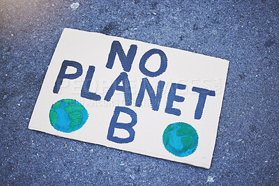 Buy stock photo Protest poster, billboard or climate change sign on city street for planet earth, globe or world sustainability. Zoom on abstract cardboard banner in future global warming or eco environment security