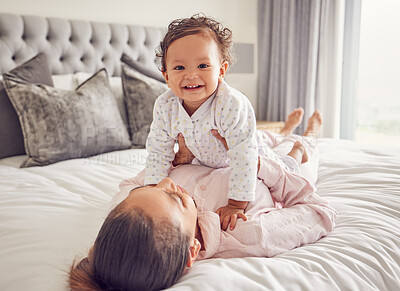 Buy stock photo Baby, family and love with a mother and her girl bonding on bed in the bedroom of their home together. Children, parent and daughter with a single mom and her cute daughter in a house with a smile