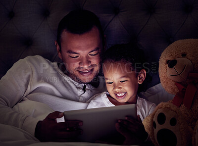 Buy stock photo Man, child and digital tablet streaming movies, cartoon or game in bed at night. Happy father and son browsing the internet, online or web with social media app while watching a comedy in the bedroom