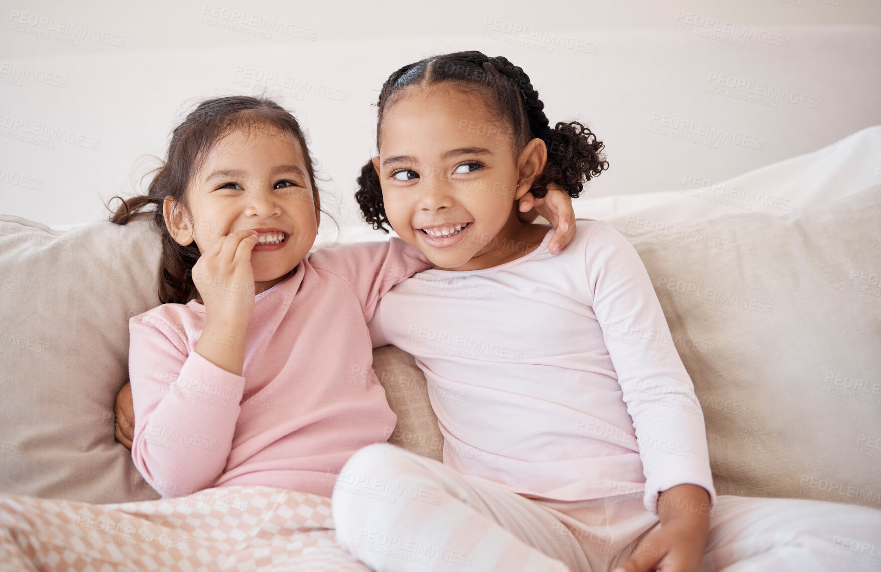 Buy stock photo Family, children and bonding by sisters on a sofa, laugh and relax while sharing a secret in a living room. Happy, play and cheerful girls enjoying a fun morning together, looking sweet and cute