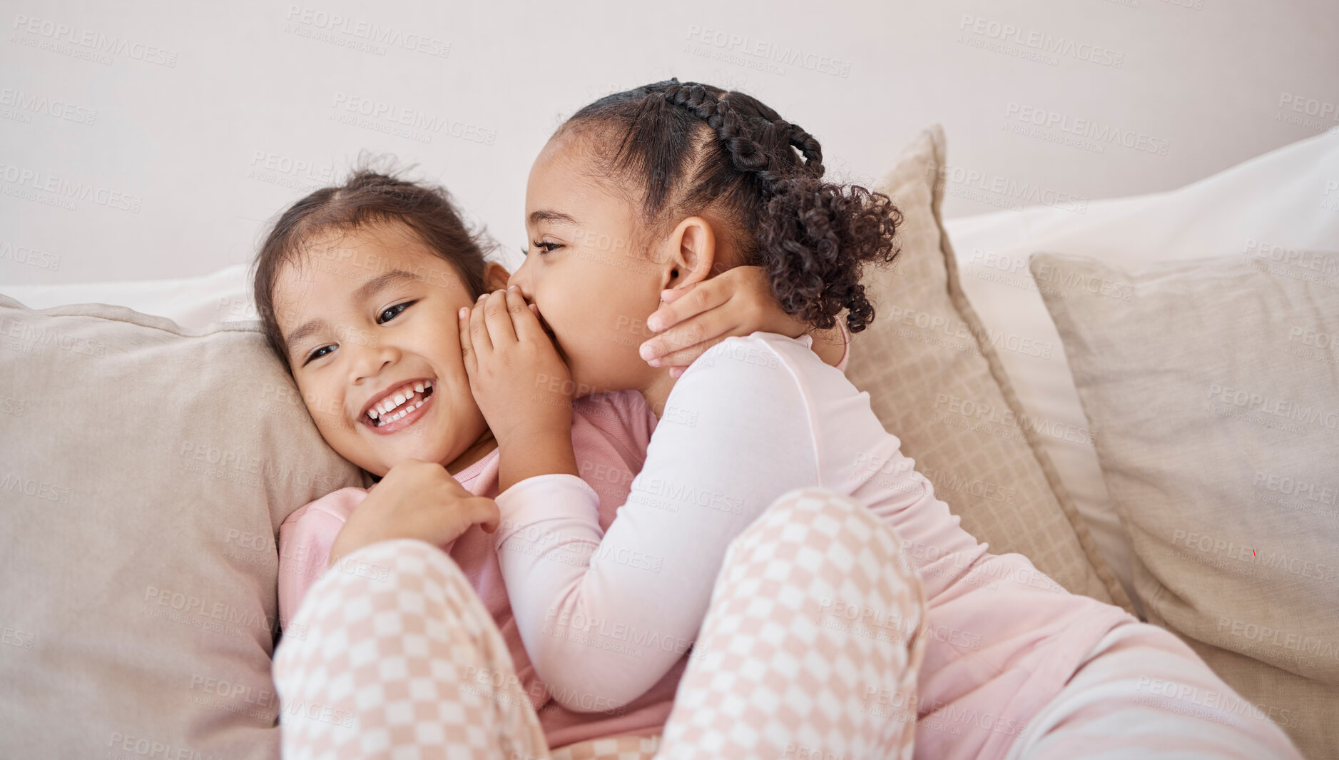 Buy stock photo Girl, friends or children whisper secret to best friend on home sofa while relax together on play date. Communication, conversation and sisters or youth kids gossip at fun slumber party or sleepover