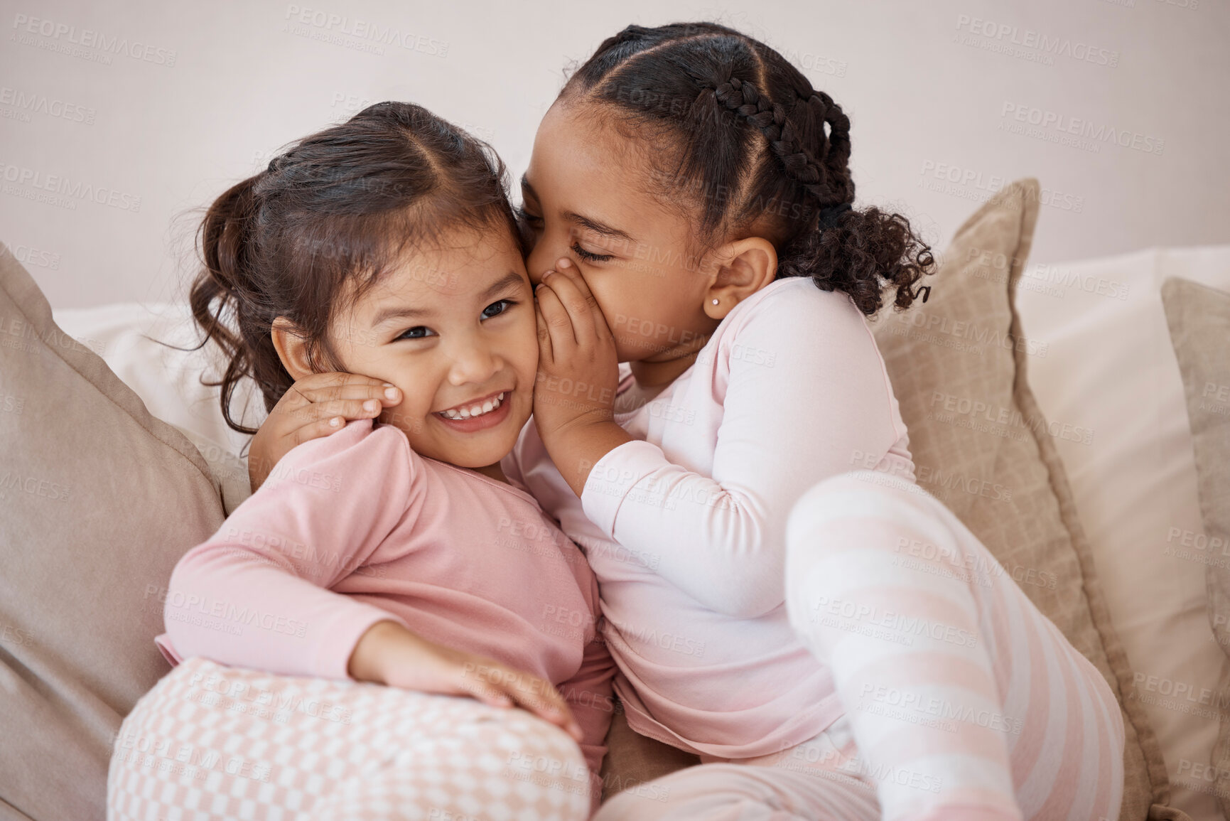 Buy stock photo Children, secret and girls whispering in ear with love, trust and happiness while playing on a sofa at home. Interracial, adoption and bond between girl siblings, sister friends and kids having fun
