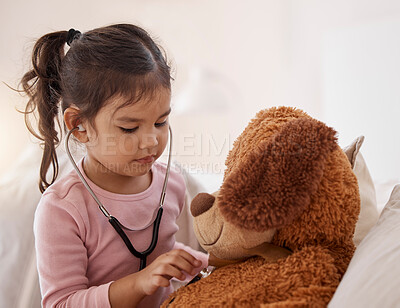 Buy stock photo Stethoscope, girl and a teddy bear playing future doctor game showing care on a good health insurance checkup. Cute small child listening or checking stuffed animal medical heartbeat at home