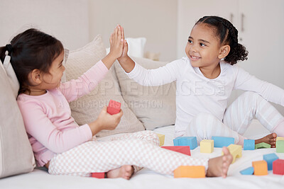 Buy stock photo High five, children and fun playing with learning blocks and celebrating achievement or development with colorful toys at home, Adoption and interracial girls, friends or sisters bonding and support