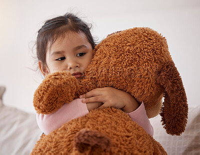 Buy stock photo Children, fear and scary with a girl holding her teddy bear after a nightmare in her bedroom at home. Kids, anxiety and depression with a little female child hugging a stuffed animal in her house