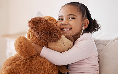 Buy stock photo Children, teddy bear and girl with a child hugging her stuffed animal with a smile in her house. Kids, happy and safe with an adorable or cute female kid holding a fluffy toy while sitting on a bed