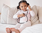 Doctor game and child portrait with stethoscope to hear heartbeat for fun play time in bedroom. Young, cute and  black kid relaxing on bed with medical check equipment to listen to heart pound.