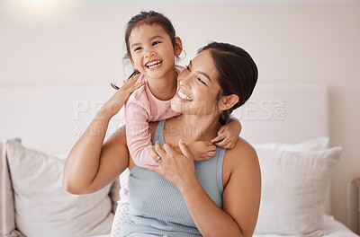 Buy stock photo Bedroom, happy and smile of mother and girl resting and spending time together on a holiday. Relax, happiness and calm woman and her child sitting on a bed and hugging in a room of their family home.
