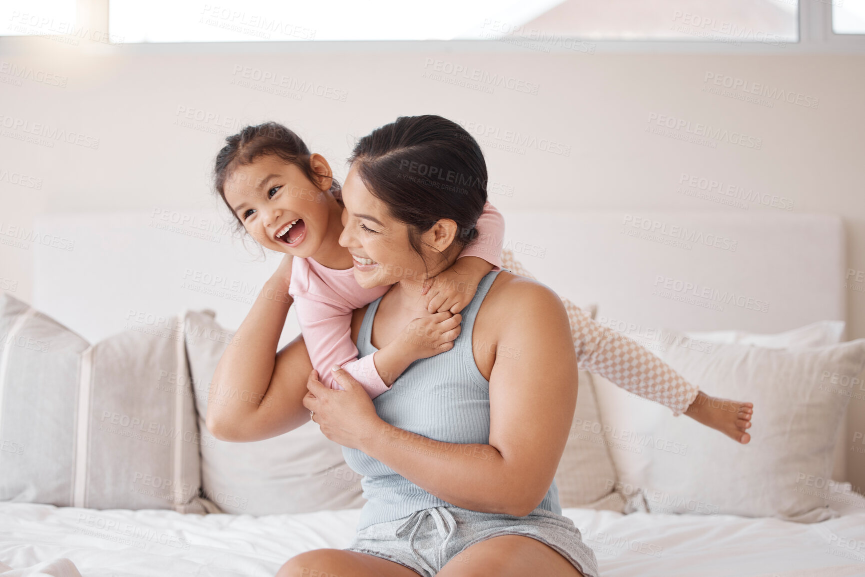 Buy stock photo Family, bedroom and mother playing with girl for fun and to relax, smile and enjoy a happy weekend together. Freedom, portrait and young child with energy smiling and hugging her lovely mom at home