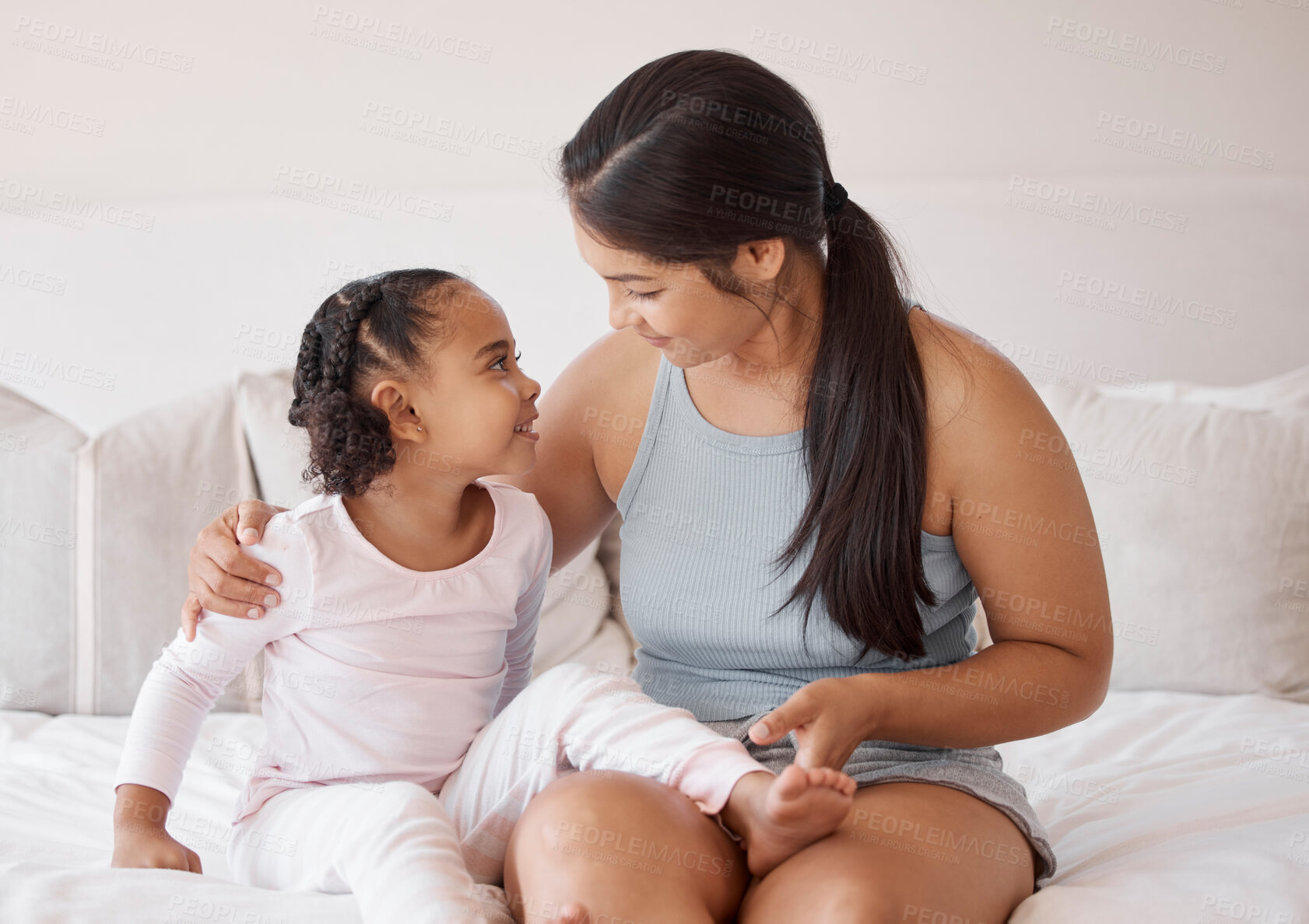 Buy stock photo Mother with girl child talk on bed, smile and love together in home bedroom. Happy woman or mom and young cute kid smiling and enjoy playful bonding and conversation as family in the morning at home 