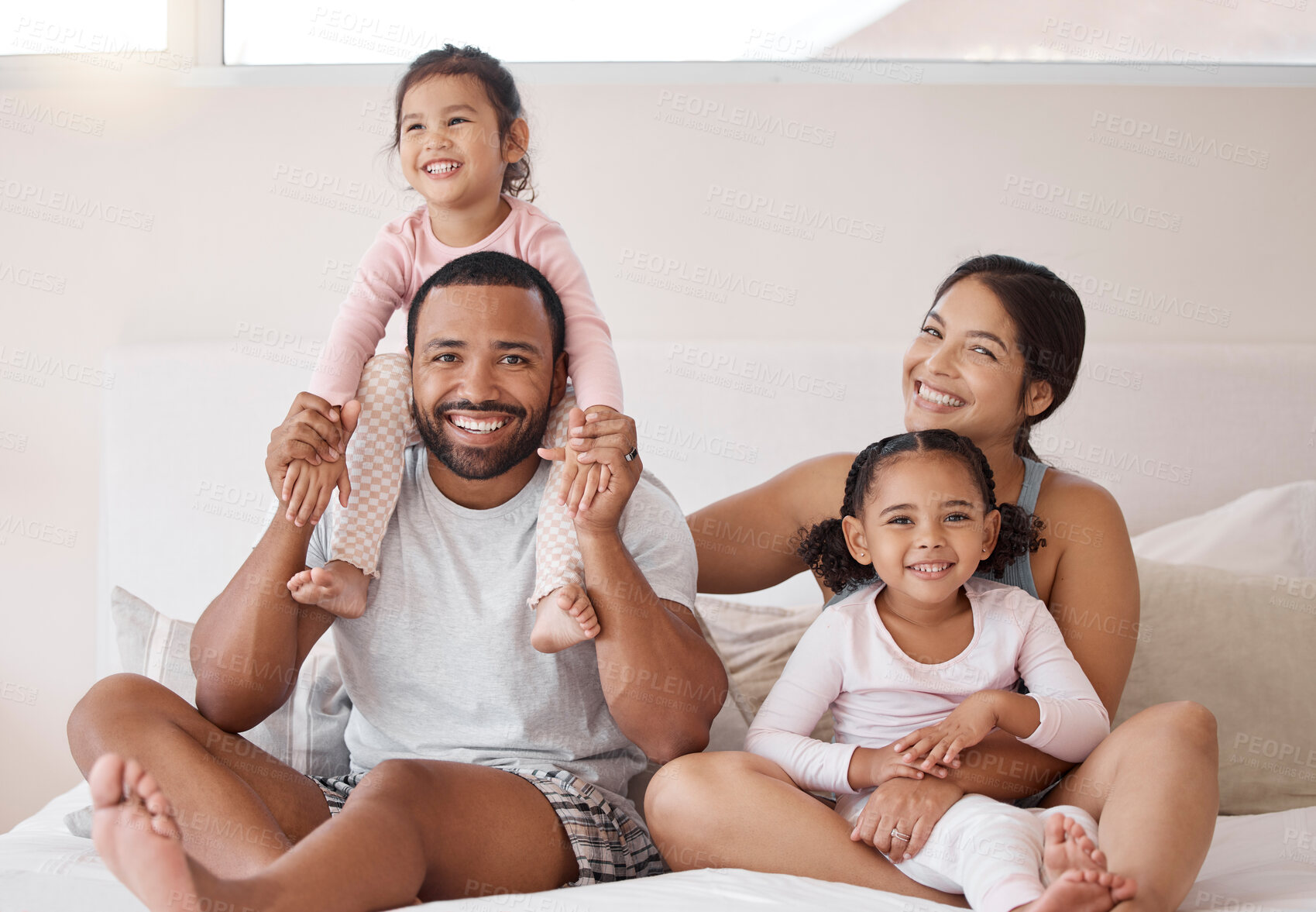 Buy stock photo Family, children and love with a man and woman sitting on a bed with their kids at home. Happy, smile and girl with her sister, mother and father relaxing together in a bedroom in their house