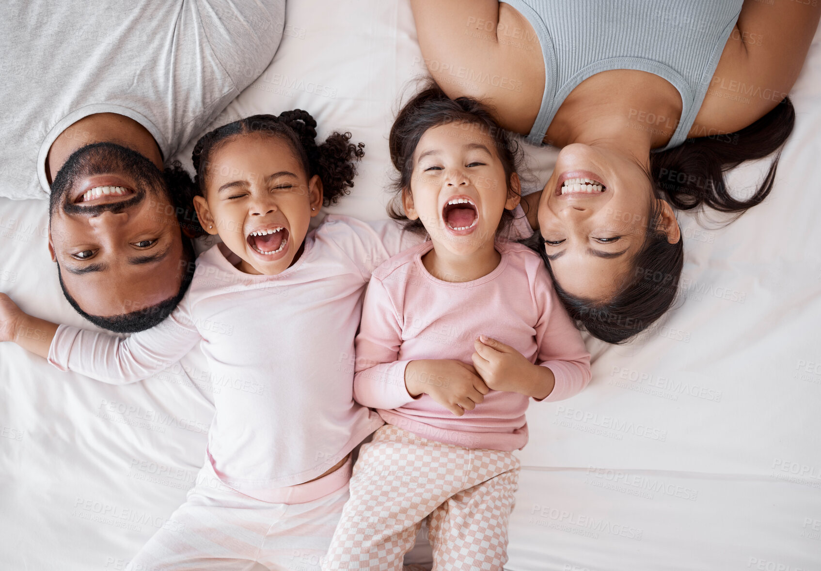 Buy stock photo Family happy, crazy children and above bed with parents in the morning, funny face in the house and comic portrait together in home. Top view of mother and dad smile with girl kids in bedroom