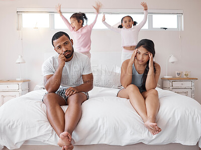 Buy stock photo Autism, headache and children with tired parents in their bedroom at home with adhd kids jumping on the bed. Family, noise and stress with a sad man and woman looking exhausted with no energy