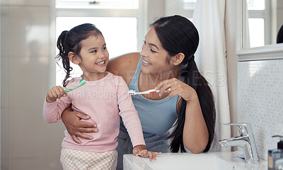 Buy stock photo Mother with girl learning to brush teeth with toothbrush together in bathroom for oral or dental wellness. Happy, love and care mom teaching child or kid about dentistry and cleaning mouth in morning