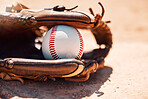 Baseball, sport and exercise with a ball and glove on a base plate on a pitch or field outdoor for a competitive game or match. Fitness, sports and skill with equipment on the ground for training