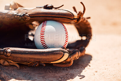 Buy stock photo Baseball, sport and exercise with a ball and glove on a base plate on a pitch or field outdoor for a competitive game or match. Fitness, sports and skill with equipment on the ground for training