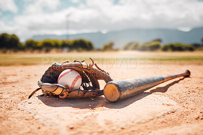 Buy stock photo Baseball, sport and empty with a bat, ball and mitt on a base plate on a pitch outdoor after a competitive game. Fitness, sports and still life with exercise equipment on the ground for training