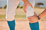 Sport, baseball and pain or injury for legs of athlete, player or sports woman on a baseball field. Emergency, accident and hurt girl holding knee after fitness, exercise and game training workout